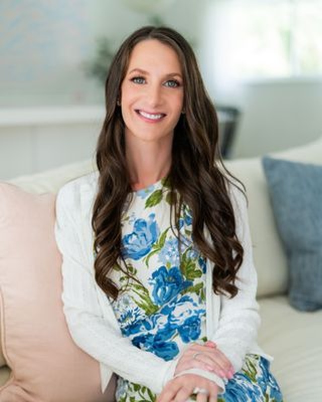 Dr. Emily Wald, Ph.D., seated in a bright office